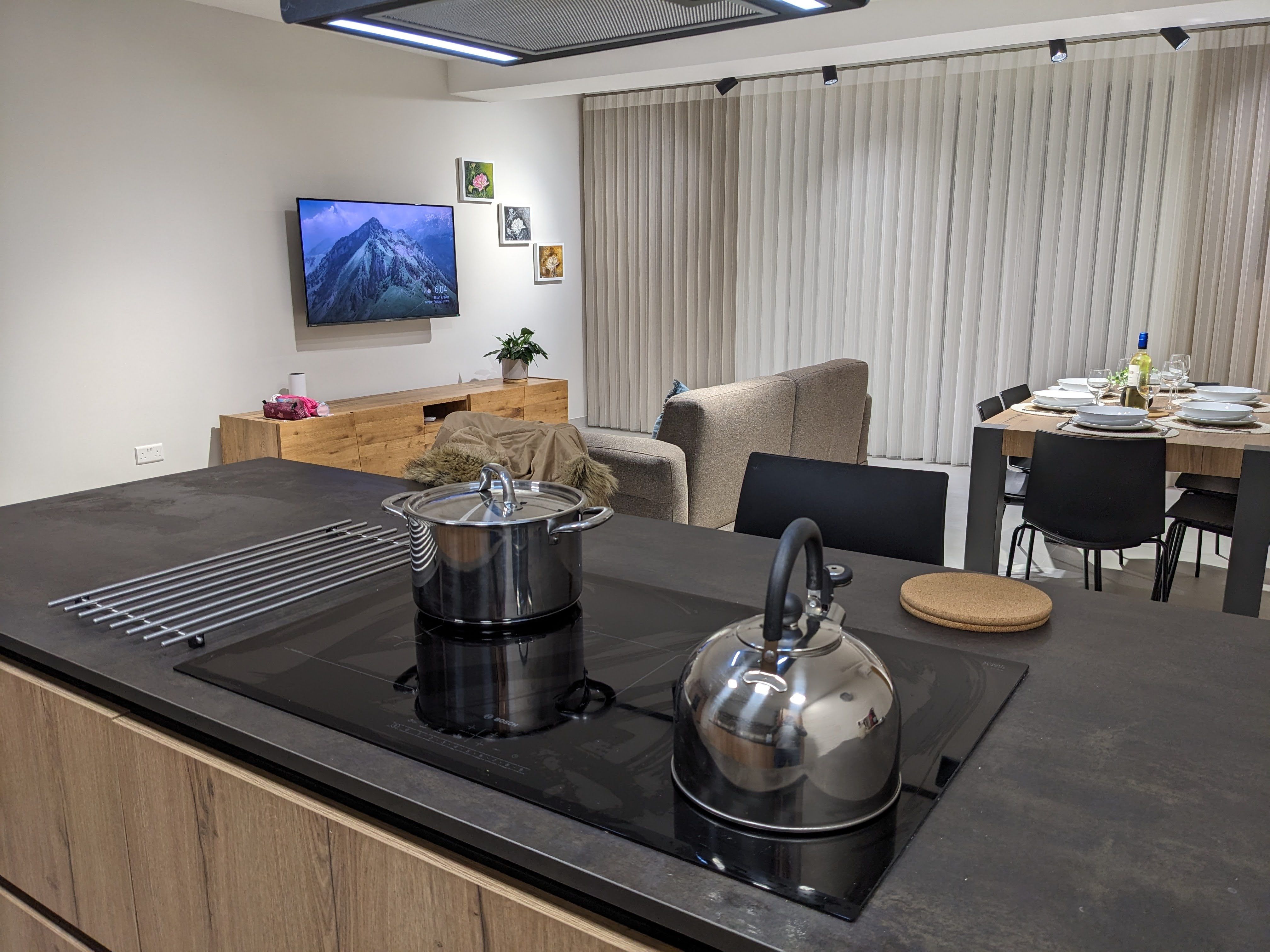 Induction hob on the kitchen island, looking through to the sofa and dining table beyond